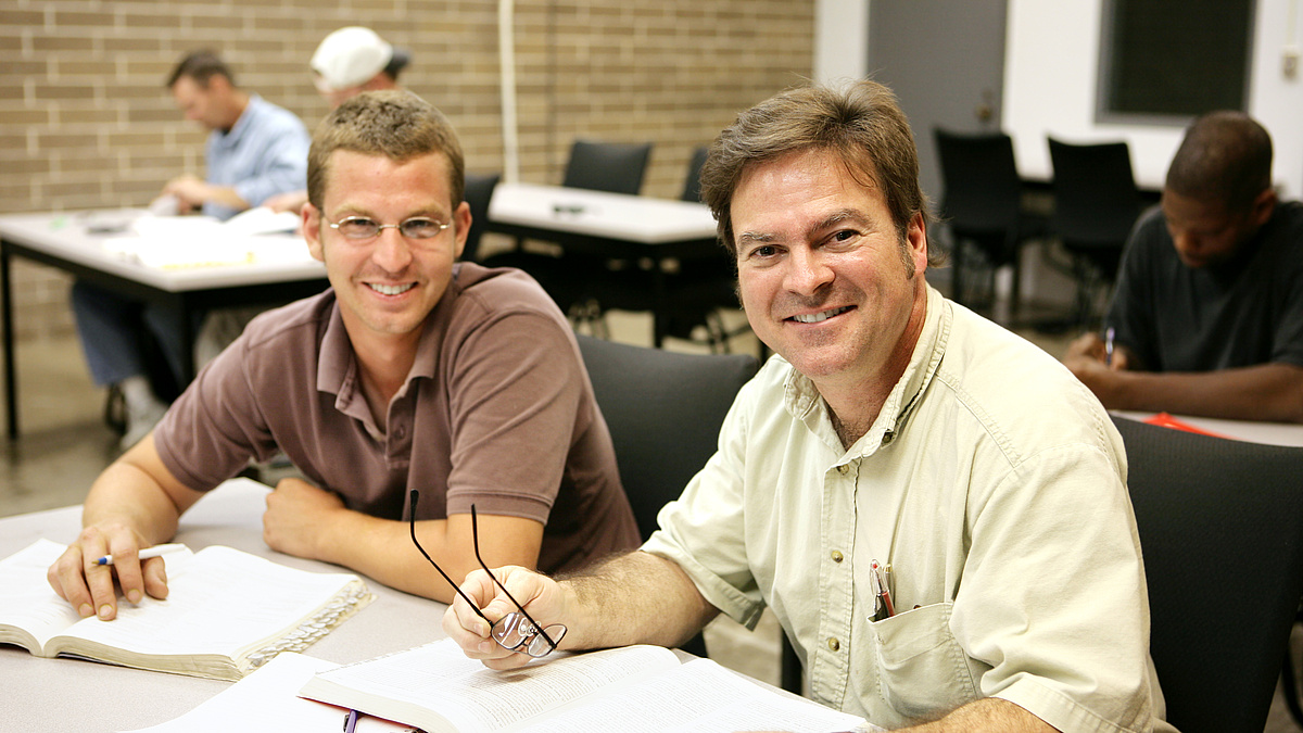 Two man sitting smiling
