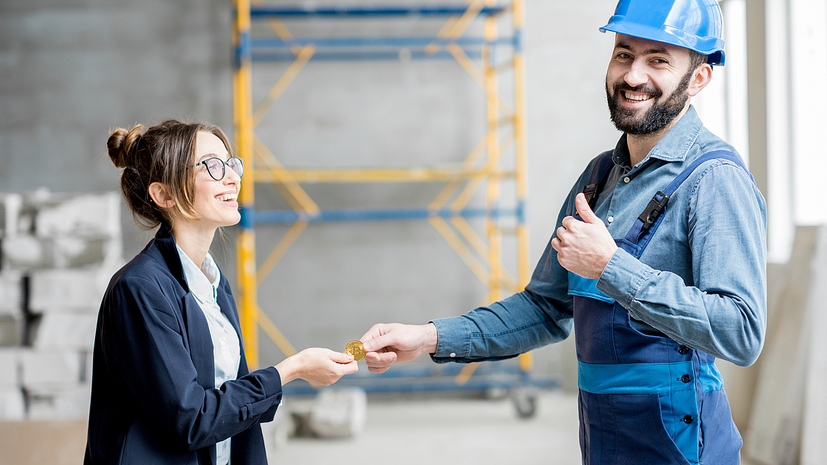 Woman giving cryptocurrency to a builder