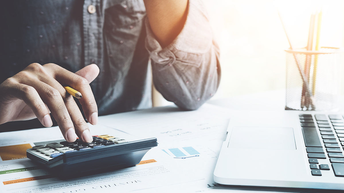Close up a man working about financial with calculator at his office to calculate expenses, Accountigng concept